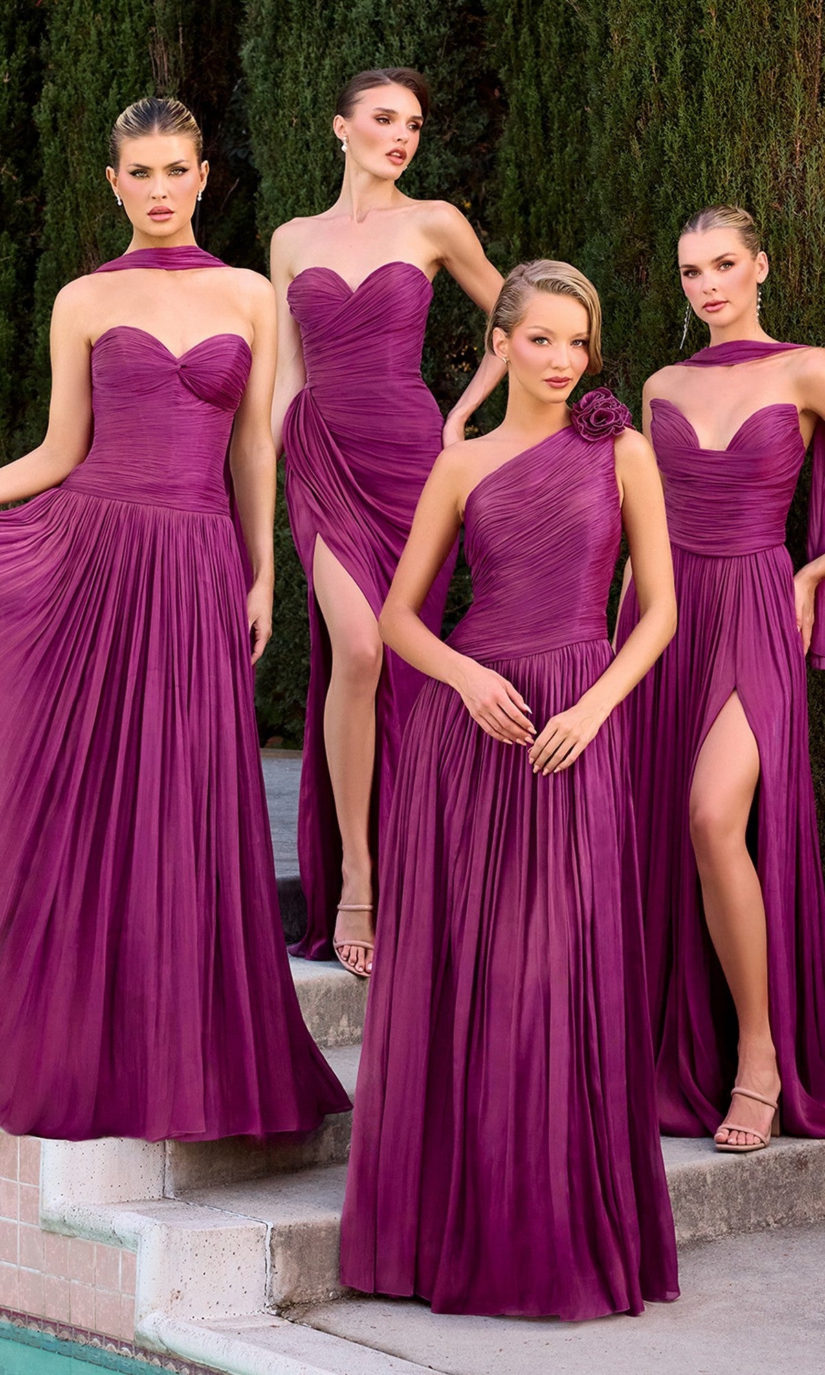 Four women by a poolside wear matching Ladivine CD415 long prom dresses in mulberry, each featuring pleated chiffon skirts and varied necklines, including an elegant one-shoulder A-line formal style.